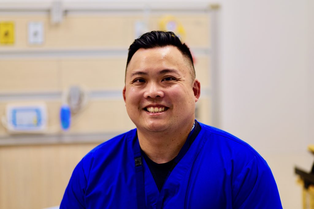 Andrew Tri, smiling Physiotherapist at an emergency department at Toronto General Hospital